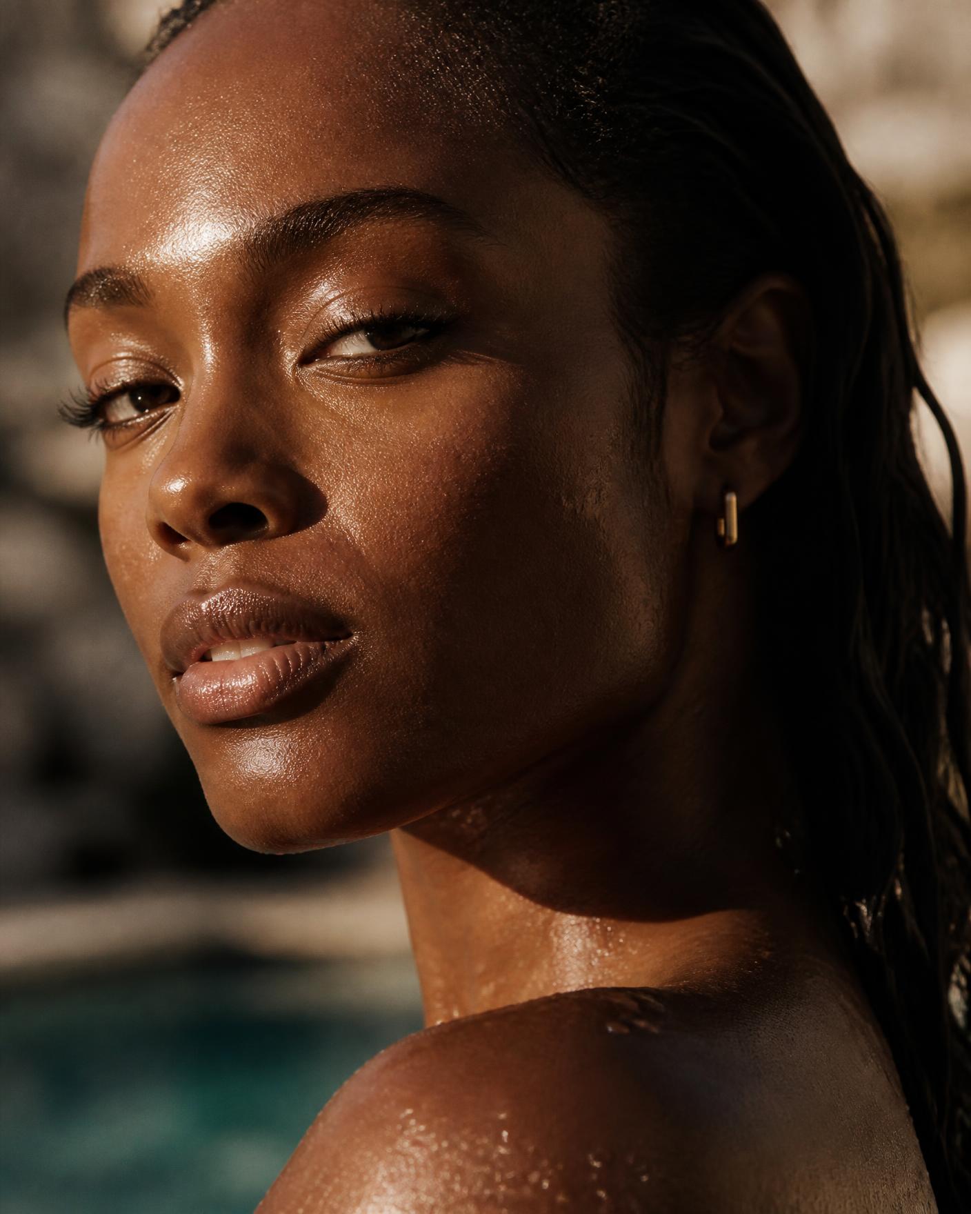Close-up of wet, slicked-back hair poolside